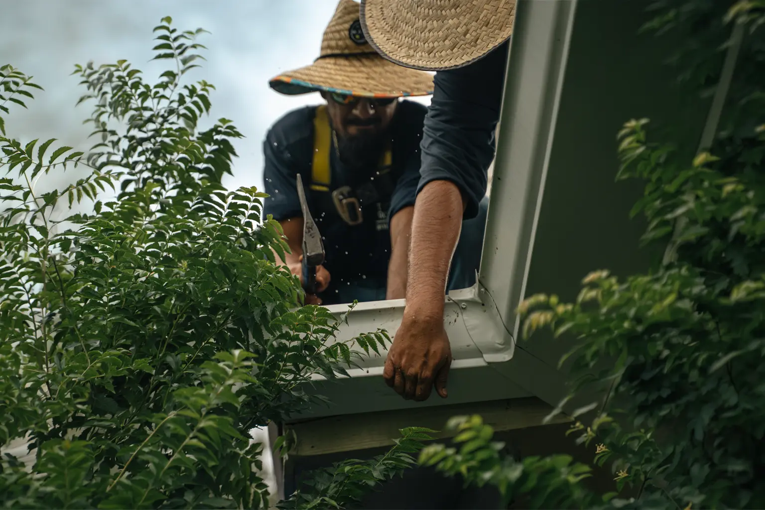 Two Trust Gutter System employees repair a gutter.